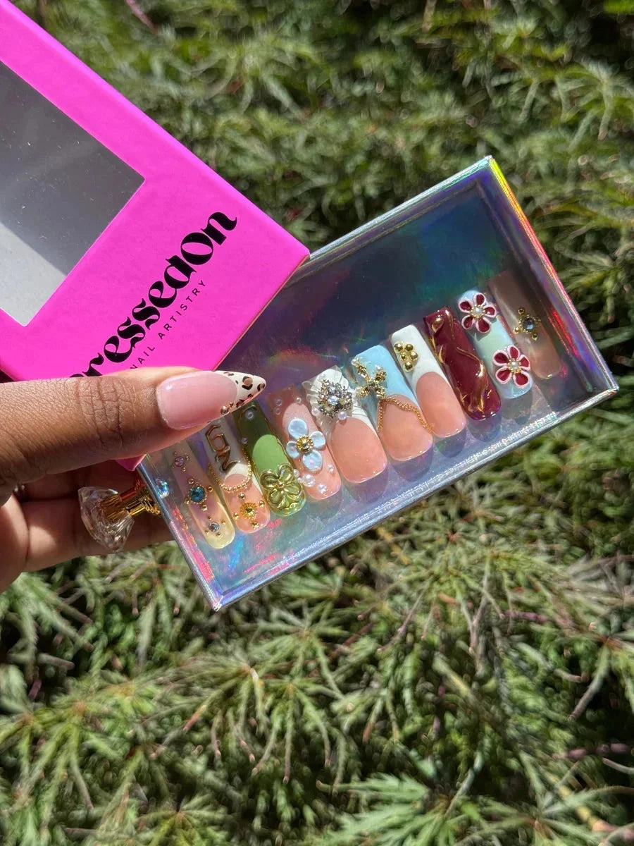 Medium length 90s vibe press-on nails featuring 3D floral and leopard designs, with a glossy finish and French tips.