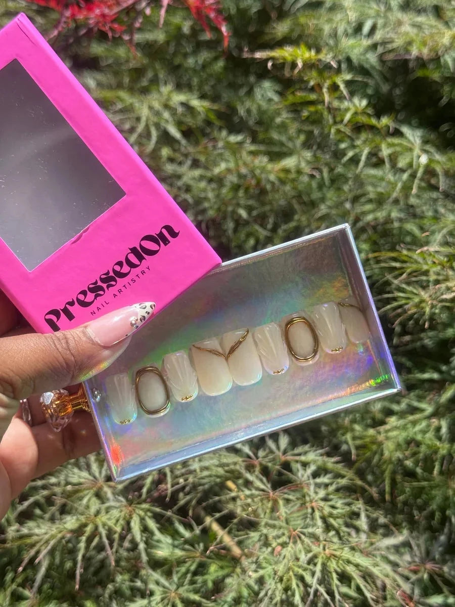 Ivory white super short press-on nails feature gold accents, gold rings and 3D detailing. These nails are perfect for bridal parties.