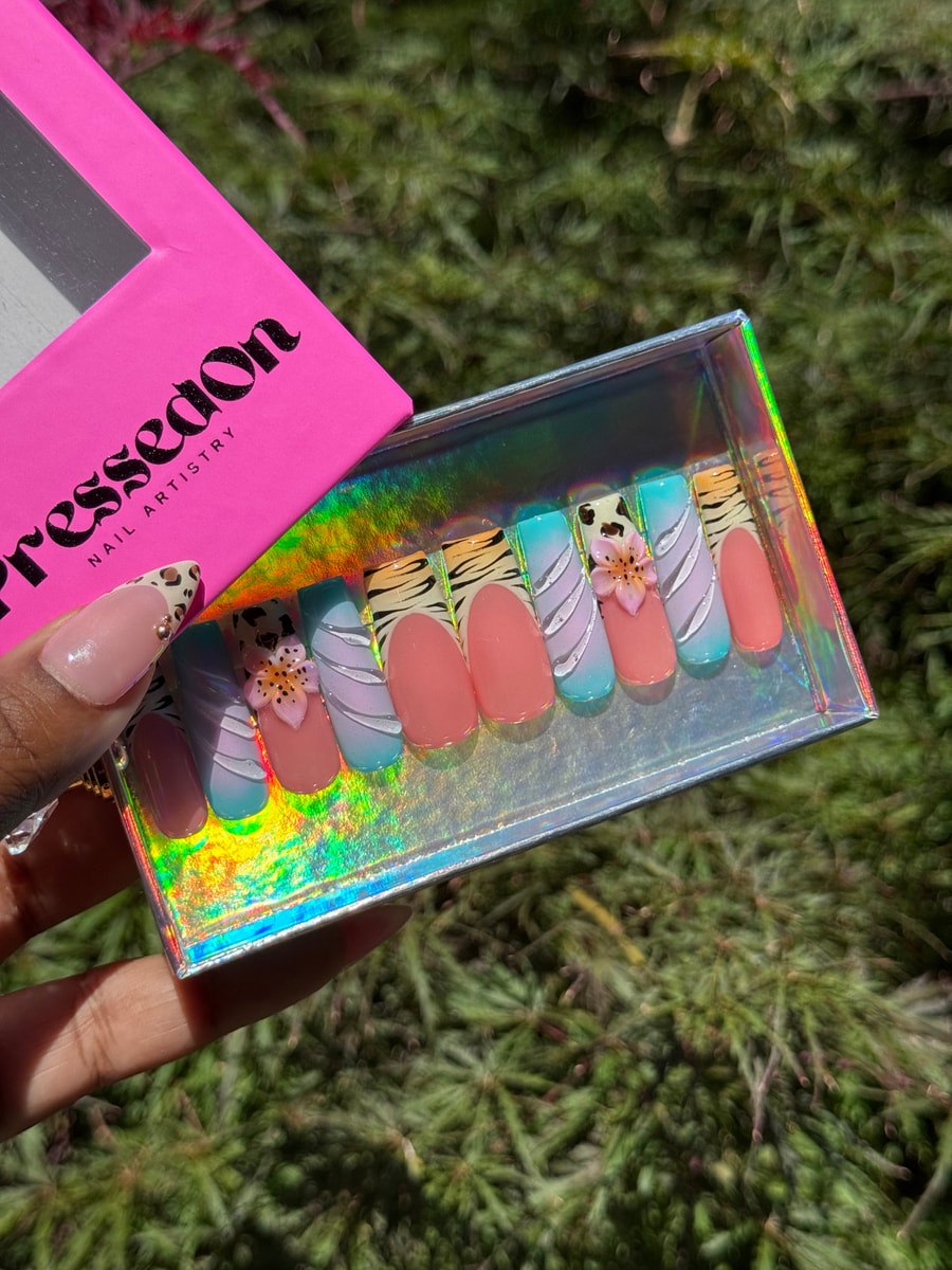 These medium press-on nails feature cheetah and zebra prints along with pastel ombre nails with white swirl designs and 3D flower charms.