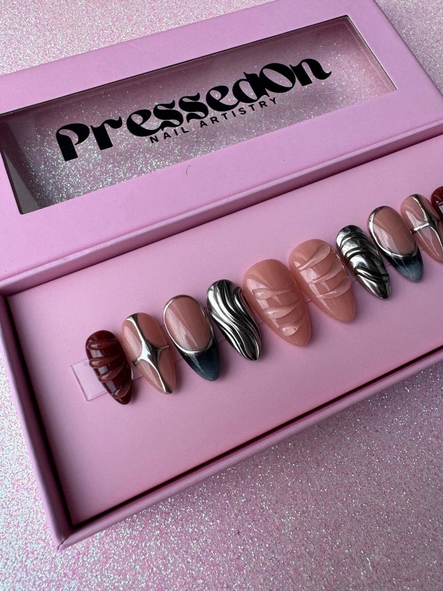 Set of super short press-on nails with nude, chrome and deep red sculpted designs. The set includes metallic silver chrome designs, glossy nude tones and textured details.