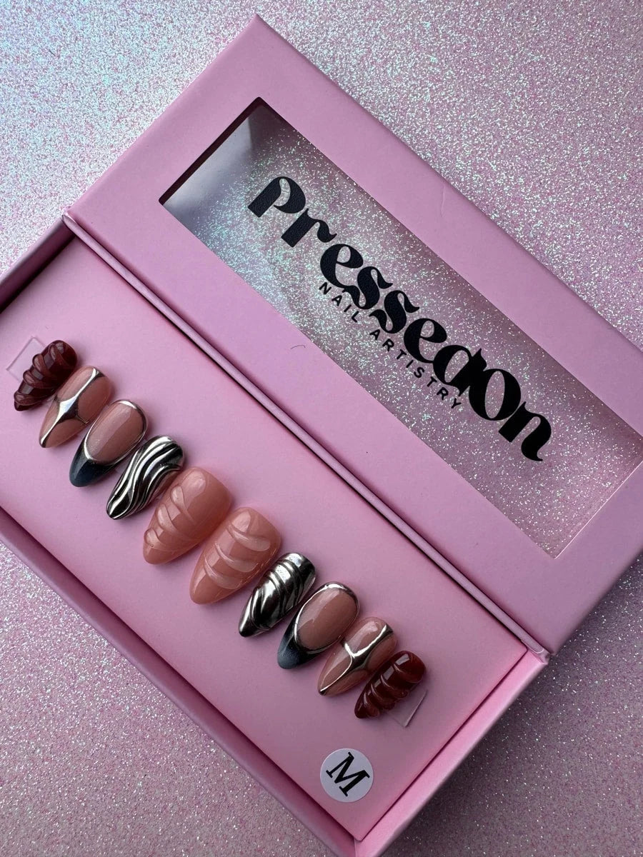 Set of super short press-on nails with chrome accents, featuring nude, silver chrome, and deep red brown sculpted designs. Includes a mix of glossy finishes and textured 3D details.