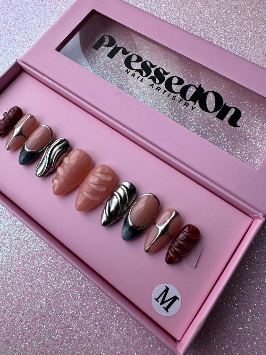 This is a set of super short press-on nails with nude, brown and silver chrome accents. Designs feature solid colors, 3D elements, and chrome details.