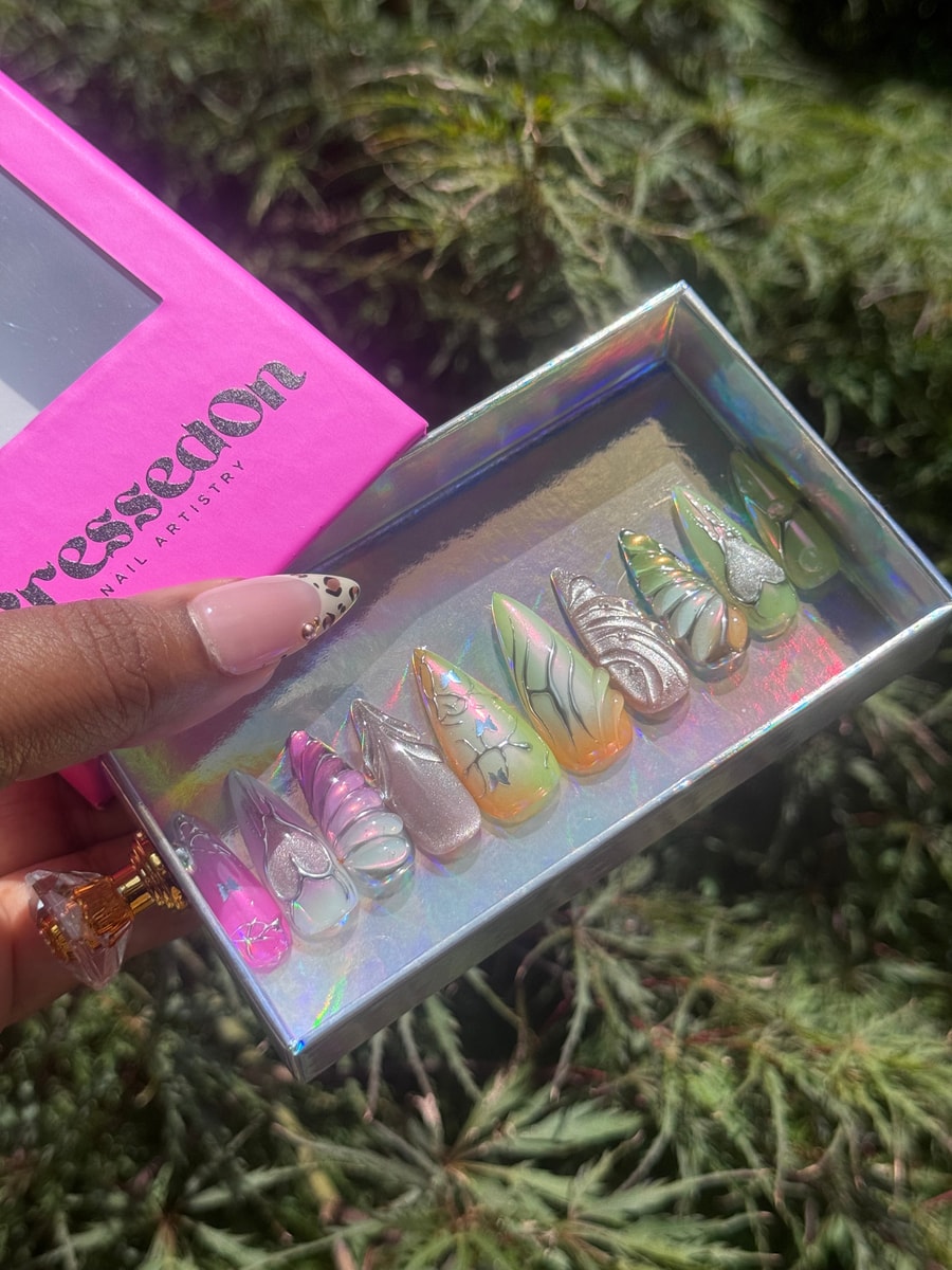 Set of medium press-on nails featuring dreamy color combinations, butterfly accents, frosted finishes, and swirling patterns.