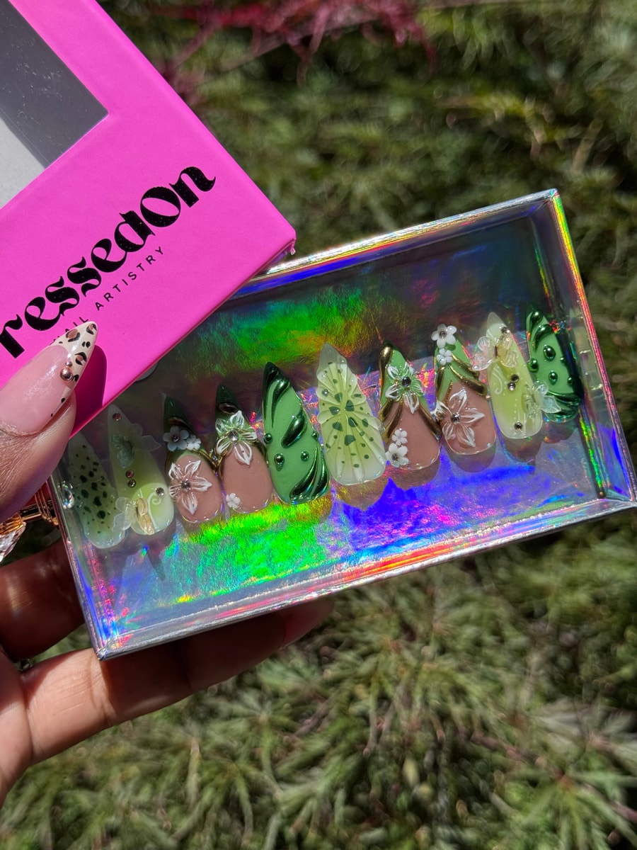 Medium length press-on nails with a kiwi green color scheme, showcasing 3D floral and butterfly wing designs, and spotted patterns.