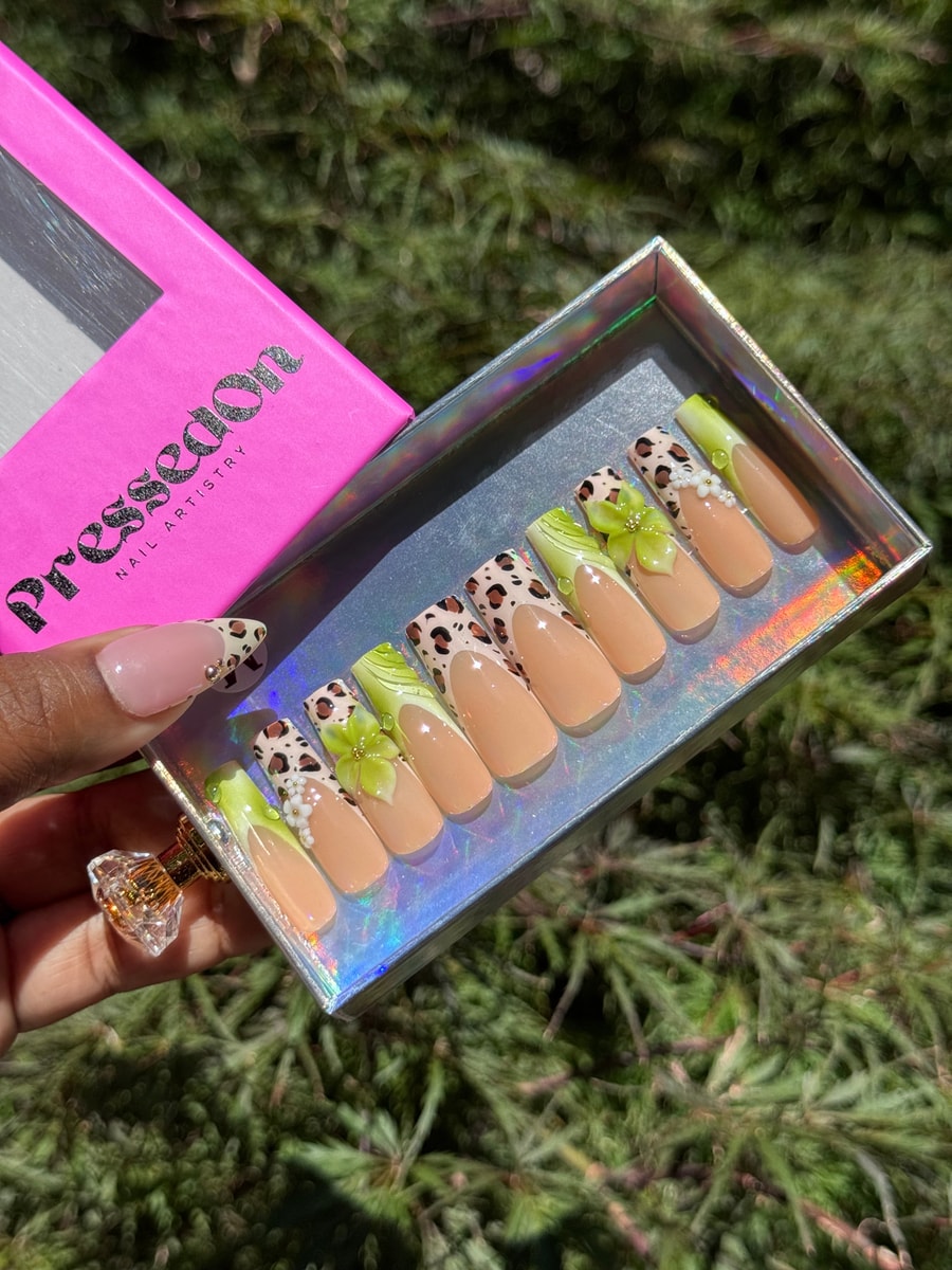 Medium press-on nails with cheetah print and lime green accents, including 3D flowers and pearl embellishments.