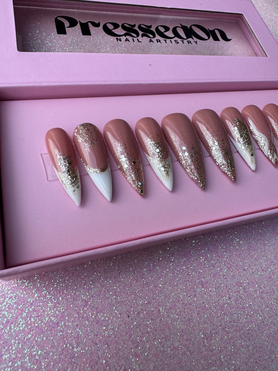 Mauve press-on nails with a unique dazzle French tip design consisting of white tips and iridescent glitter.