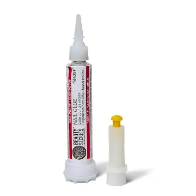 Tube of nail glue with applicator tip, used for applying press-on nails.