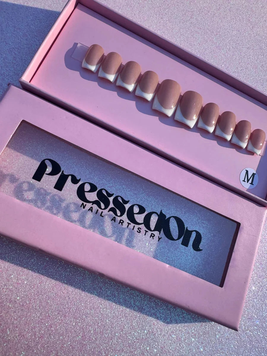 Super short press-on nails featuring a nude base with white French tips.