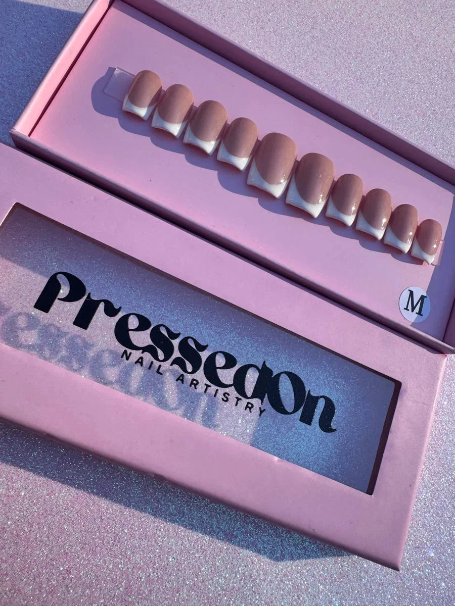 Short, square press-on nails featuring a classic white French manicure design.