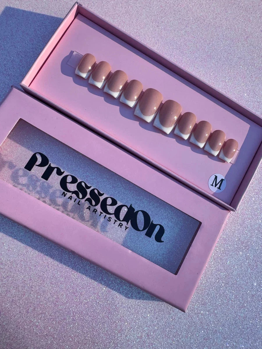 Beige super short press-on nails with a white French manicure design, providing a classic and polished appearance.