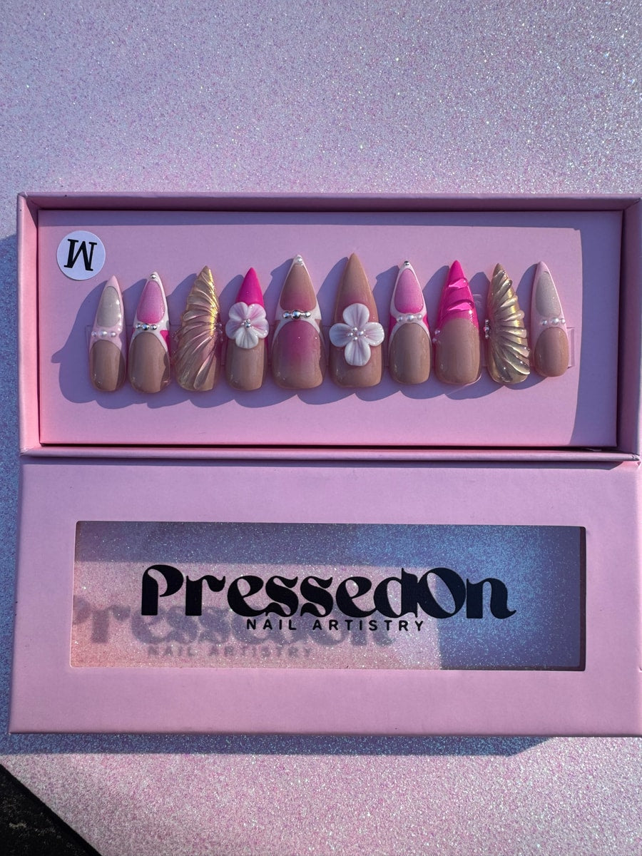 A set of pink and nude medium press-on nails with mermaid accents, pearl details, and floral decorations.