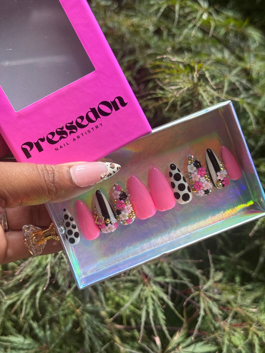 This set of press-on nails features a mix of pink, polka dot, and floral designs in short lengths. Shapes include almond and stiletto.