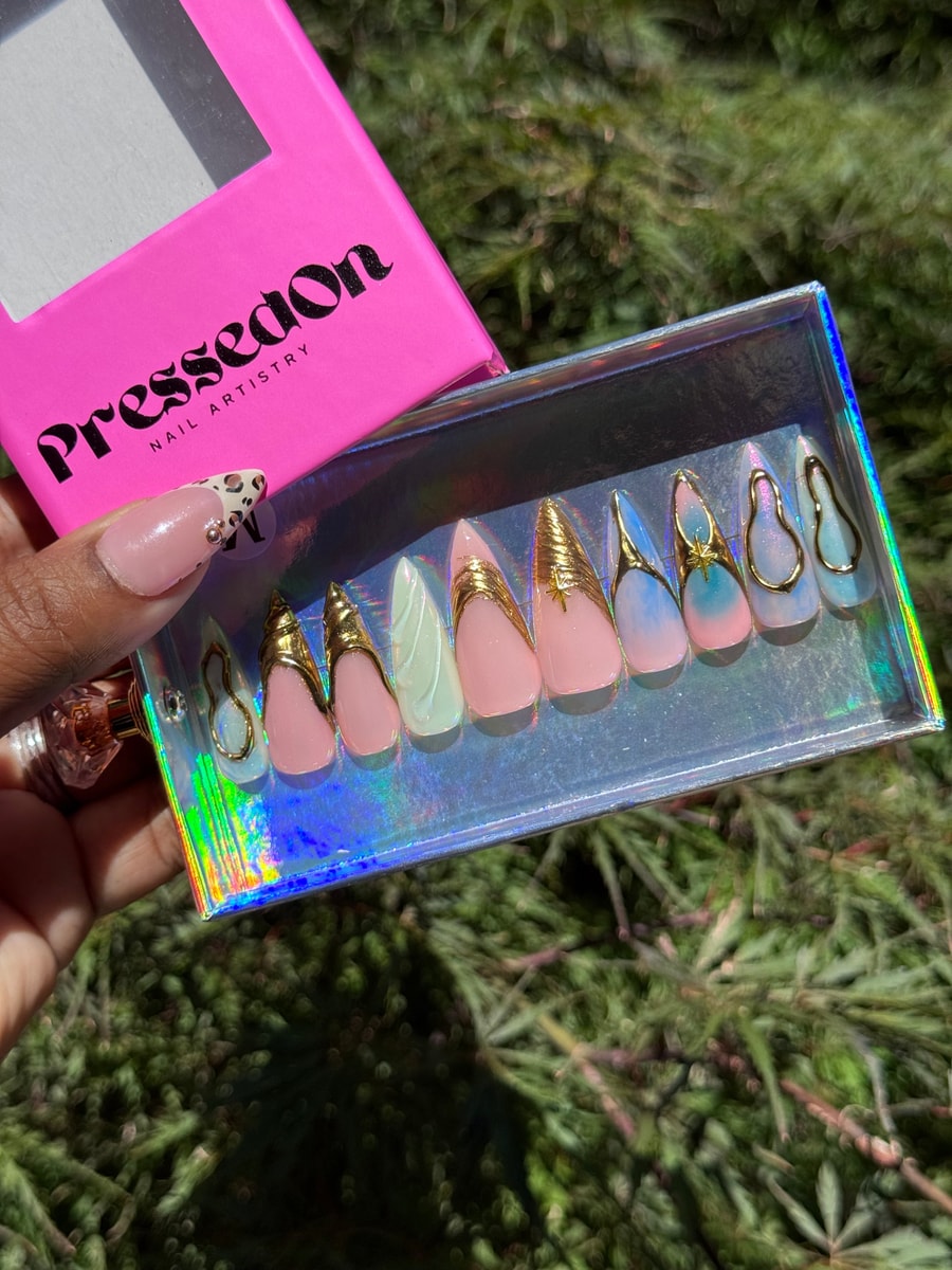 Medium-length press-on nails with pink, chrome, and gold accents in a princess style, featuring unique multi-color designs.