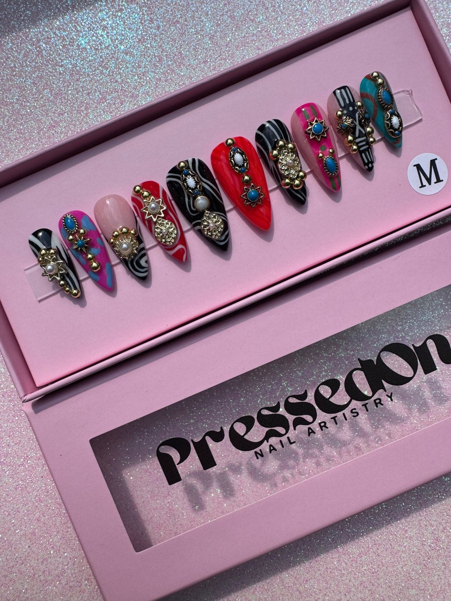Set of short decorative press-on nails with various designs featuring beads and gems.