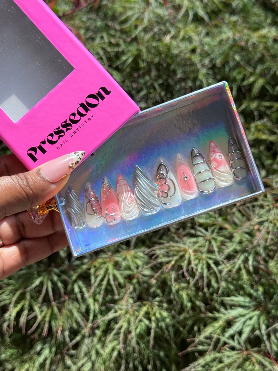 Set of medium length unicorn press-on nails with white and pink shades, and silver wire abstract designs.